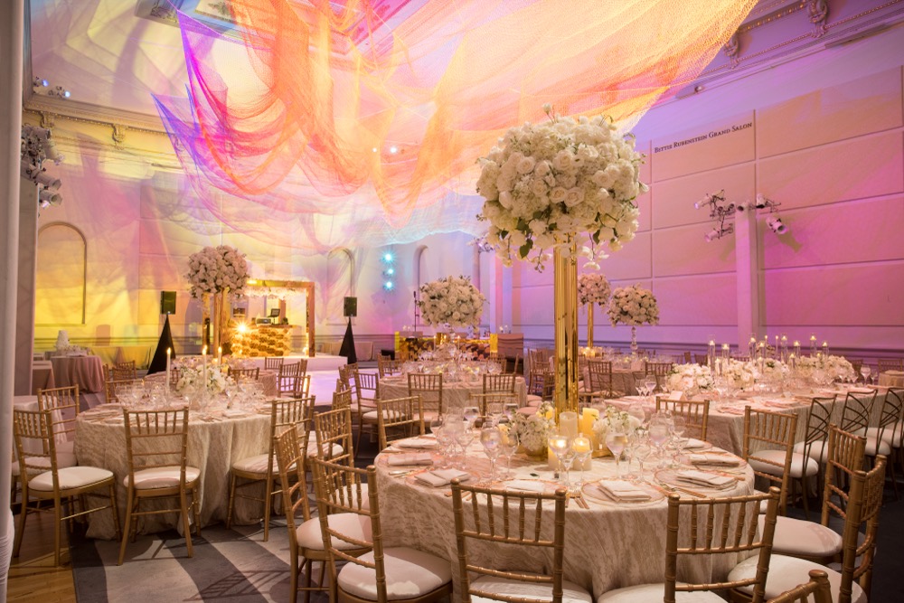 Grand ballroom reception with suspended white sphere floral installations