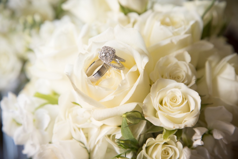 Ivory roses and waxflower arrangement, up close